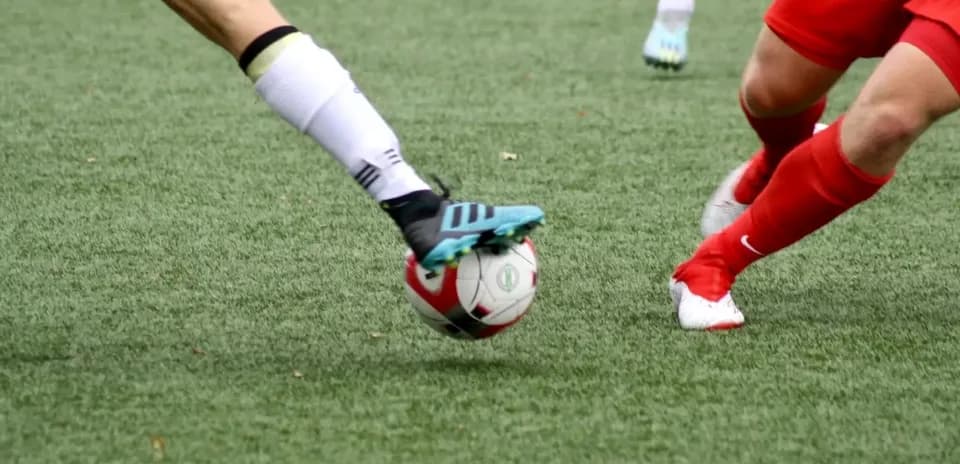 Players competing for the ball during football match