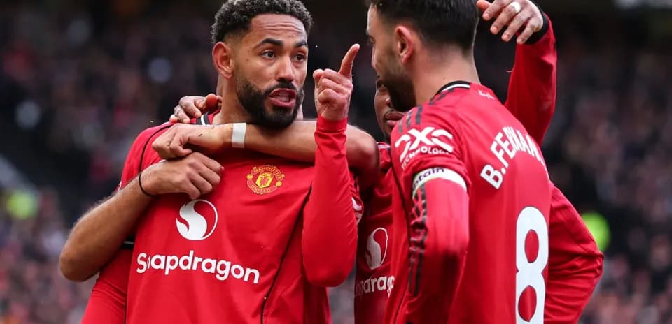 Manchester United players celebrating a goal together