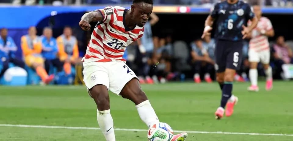 Player in striped jersey kicking soccer ball during match