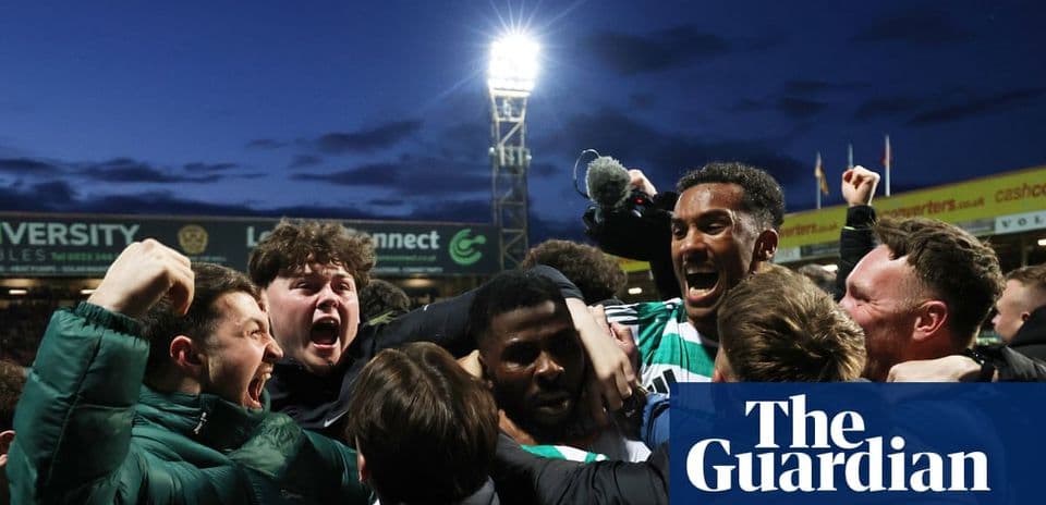 Fans celebrating a goal at a football match