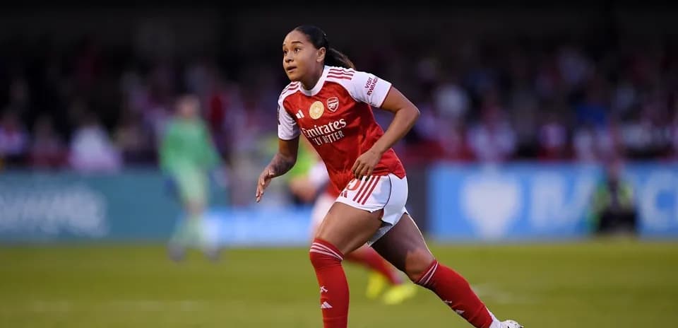 Player running on the pitch in Arsenal kit
