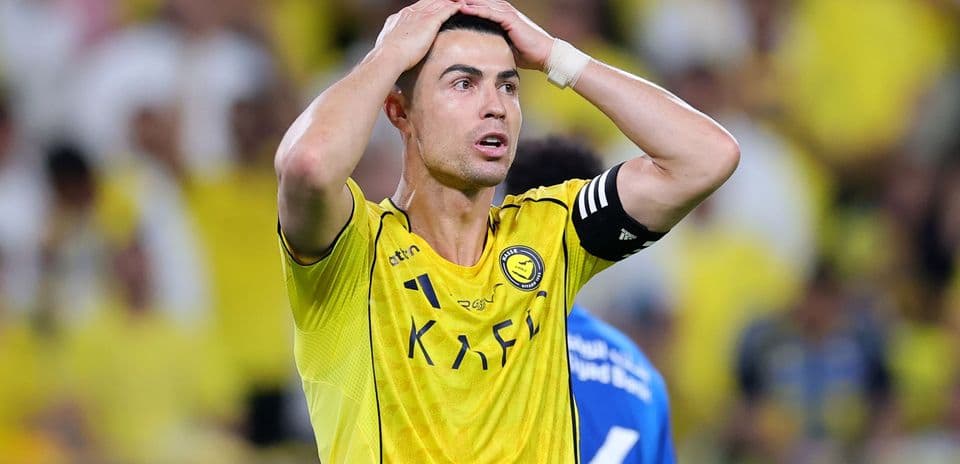 Player in yellow jersey with hands on head