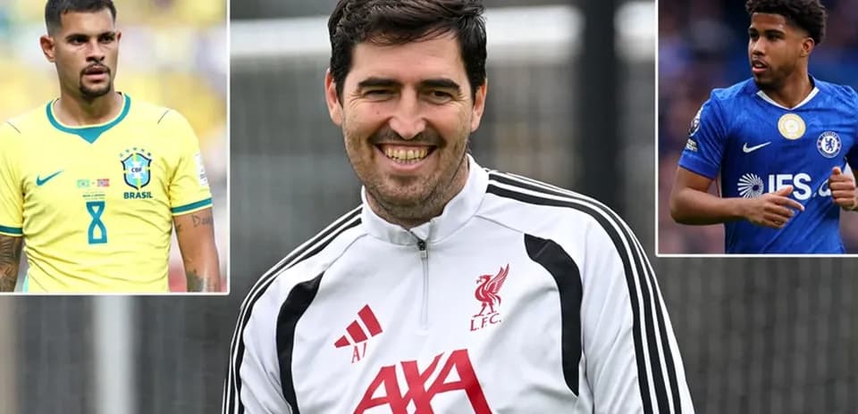 Liverpool coach smiling with players' images beside him