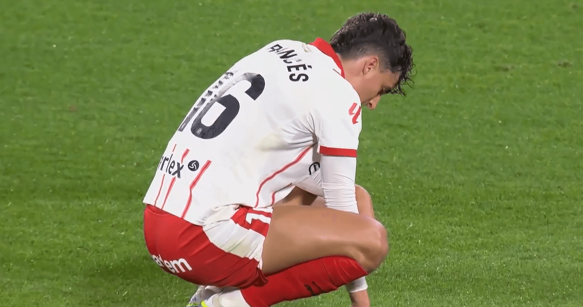 Girona player kneeling on the field during match