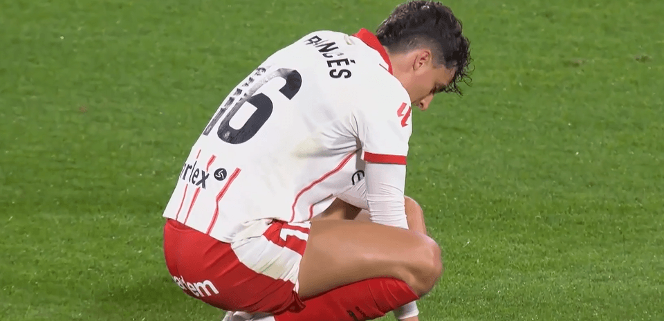Girona player kneeling on the field during match