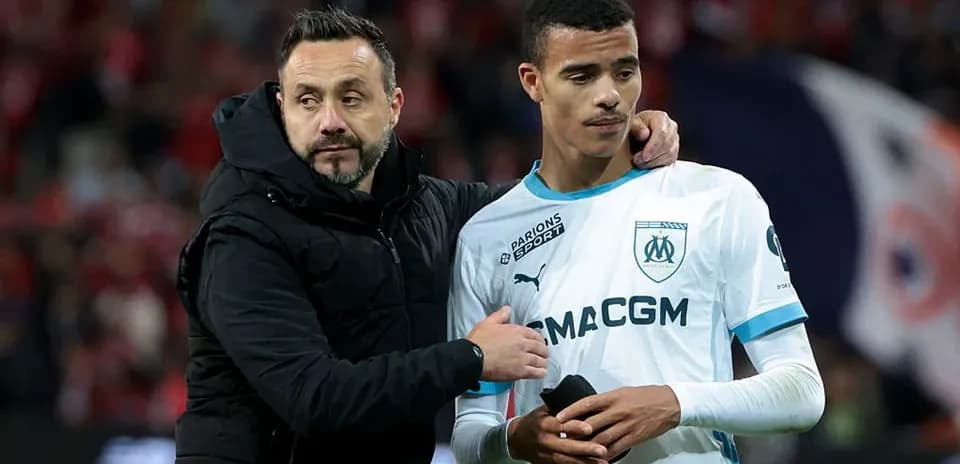 Coach comforting player after match on the field
