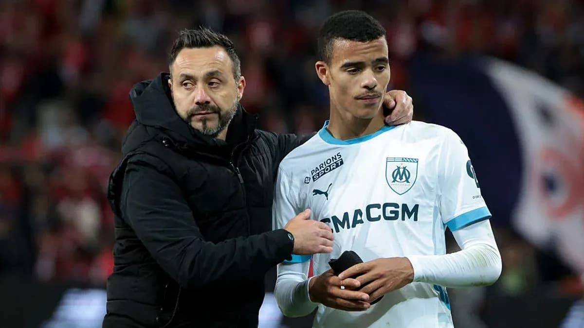 Coach comforting player after match on the field