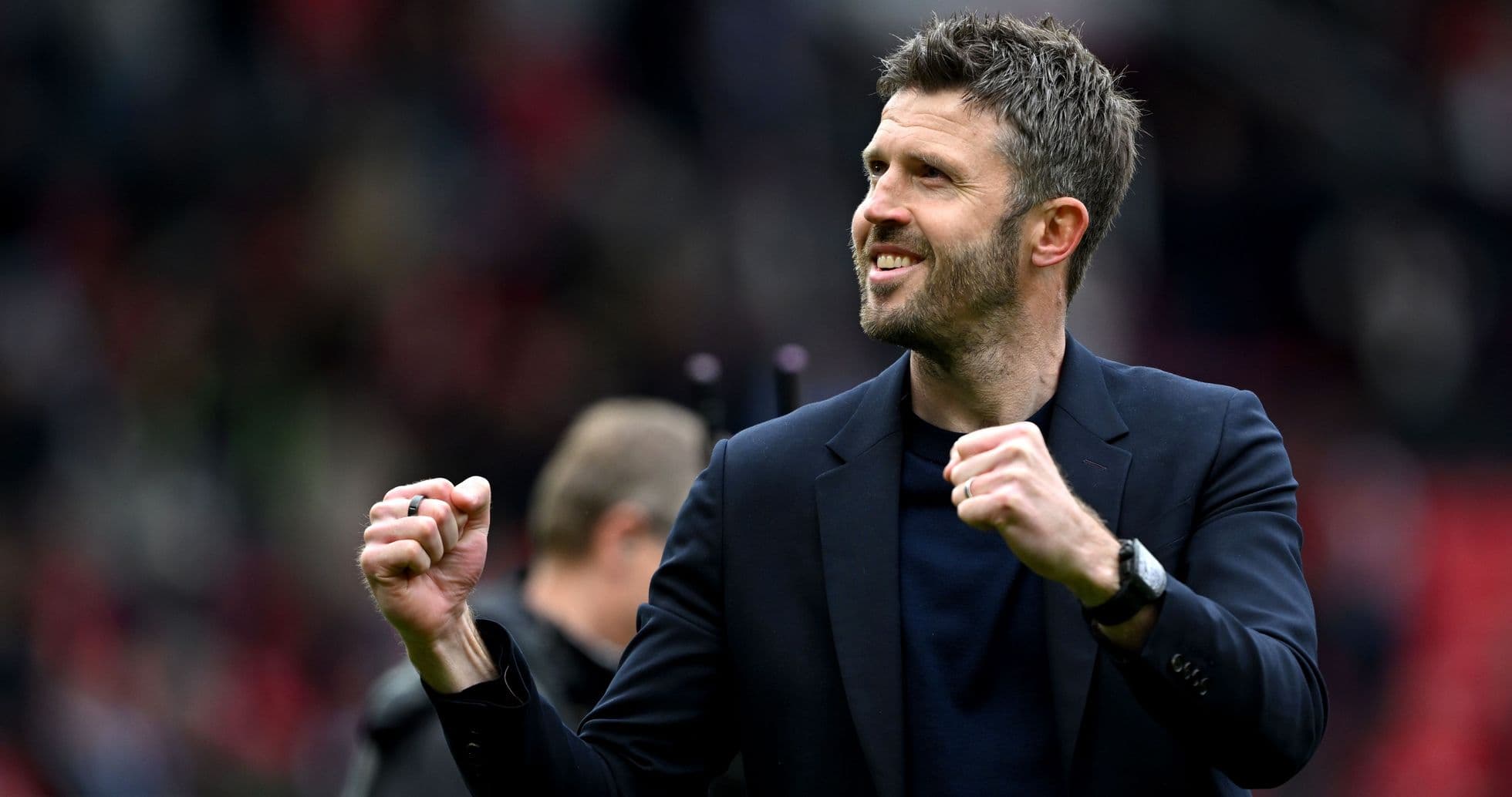 Manager celebrating with clenched fist on pitch