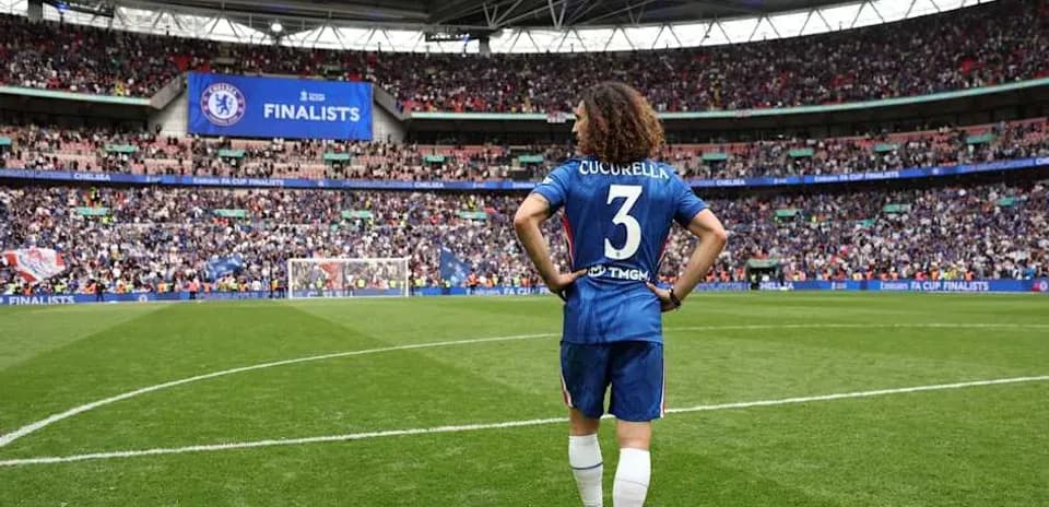 Chelsea player Cucurella on pitch at Wembley Stadium