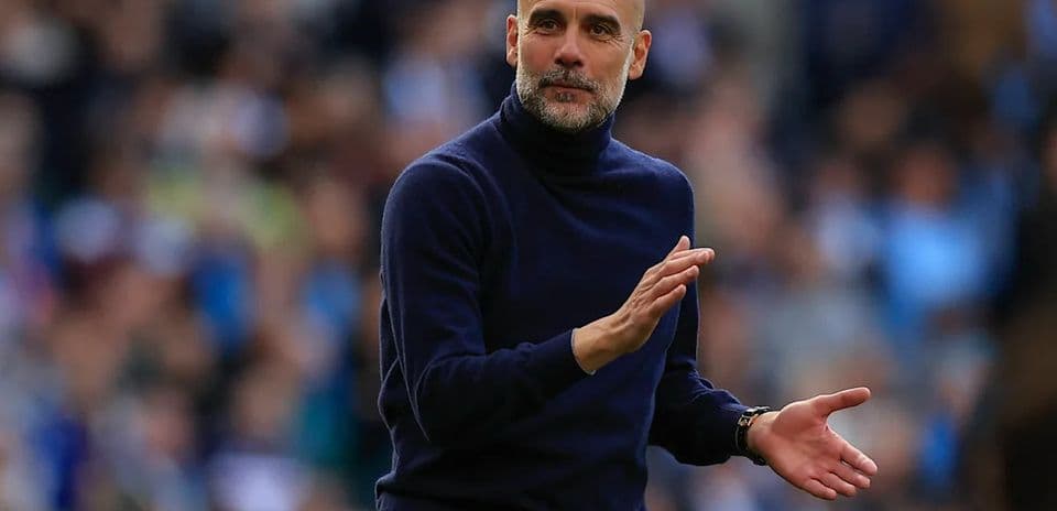 Manager gesturing during a match on the sidelines