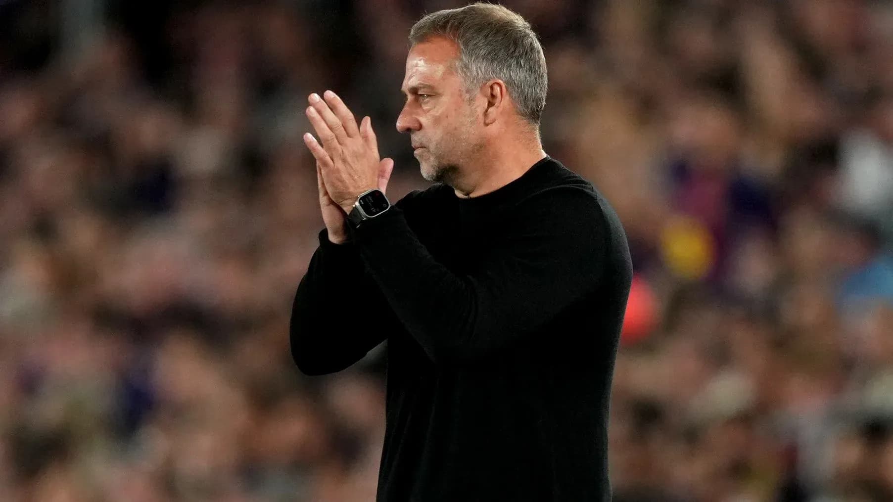 Coach applauding during a football match