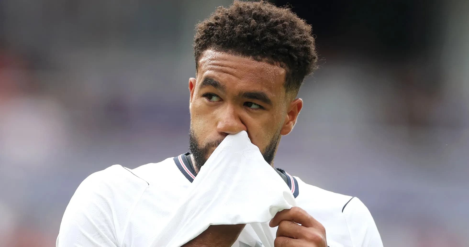 Player wiping face with jersey during match