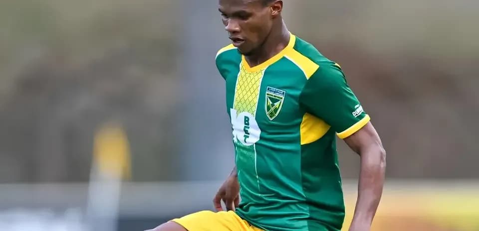 Player in green and yellow uniform during match