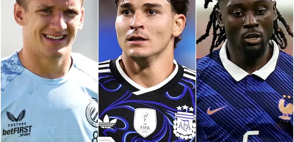 Three soccer players in team jerseys facing forward