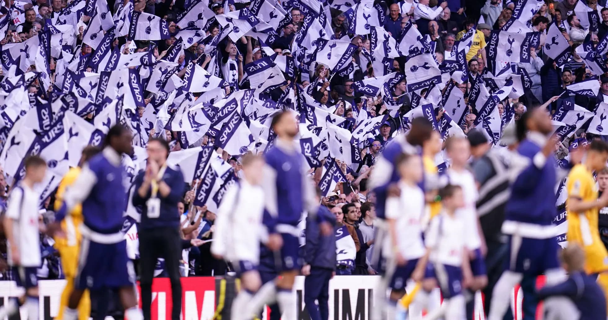 Fans waving Tottenham Hotspur flags during match