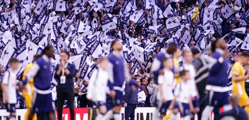 Fans waving Tottenham Hotspur flags during match