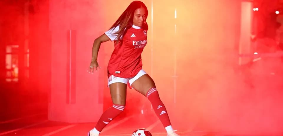 Player in Arsenal kit performing with soccer ball
