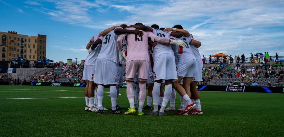 Greenville Triumph players huddling before the match