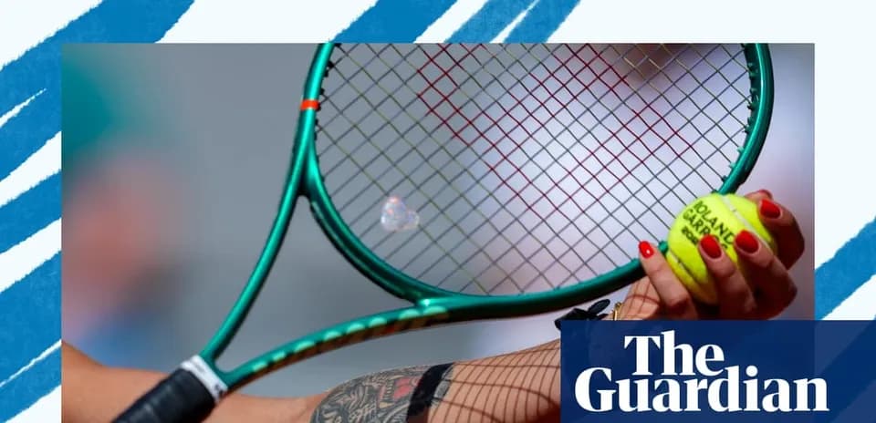 Close-up of a hand holding a tennis racket and ball
