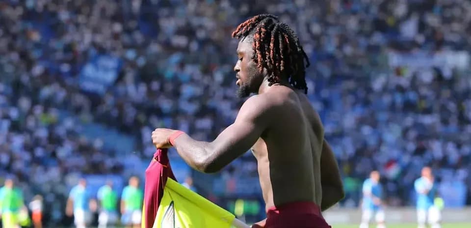 Player changing jersey on the field during match