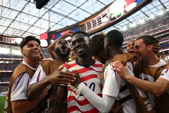 US players celebrating together after scoring a goal