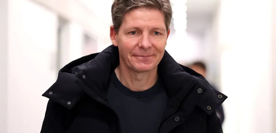 Man walking in a corridor wearing a dark jacket