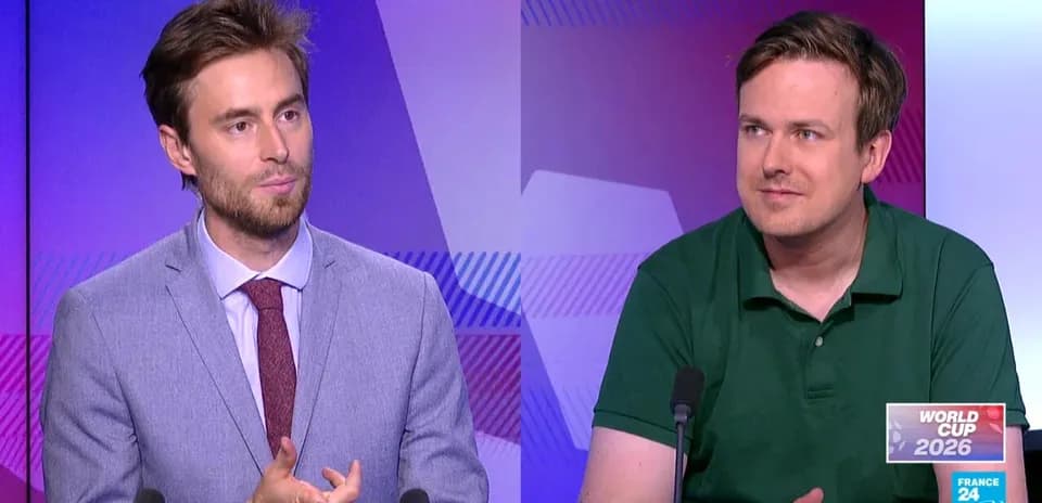 Two presenters discussing World Cup 2026 on set