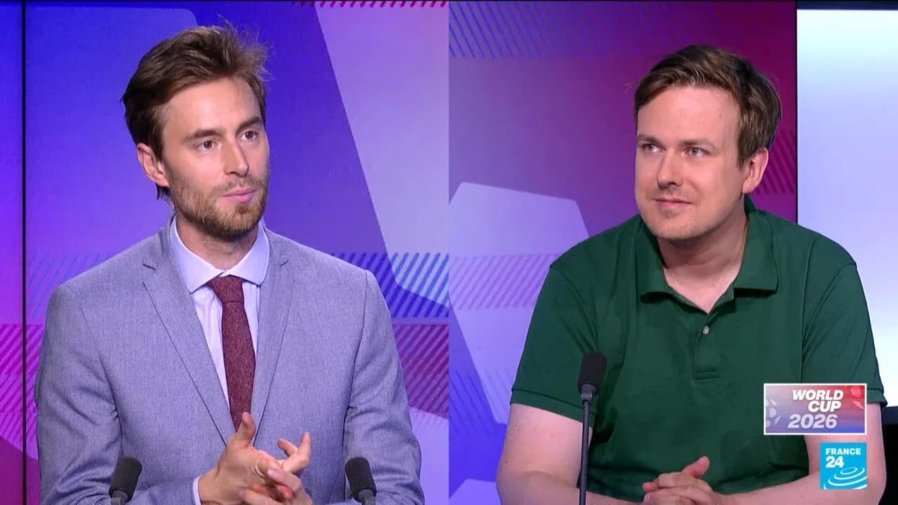 Two presenters discussing World Cup 2026 on set