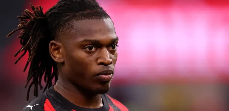 Player with dreadlocks in a black and red jersey