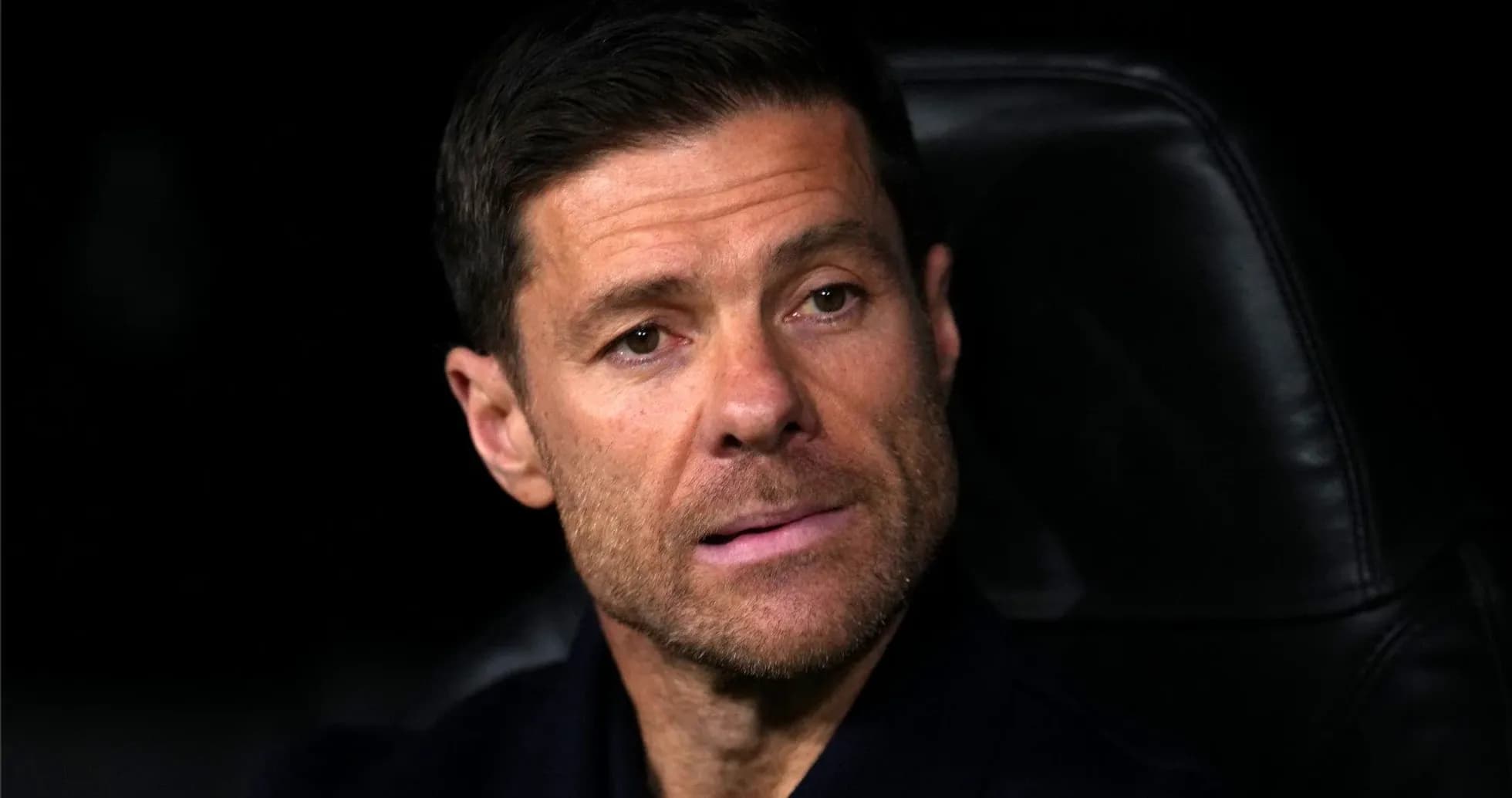 Coach seated on bench during match observation