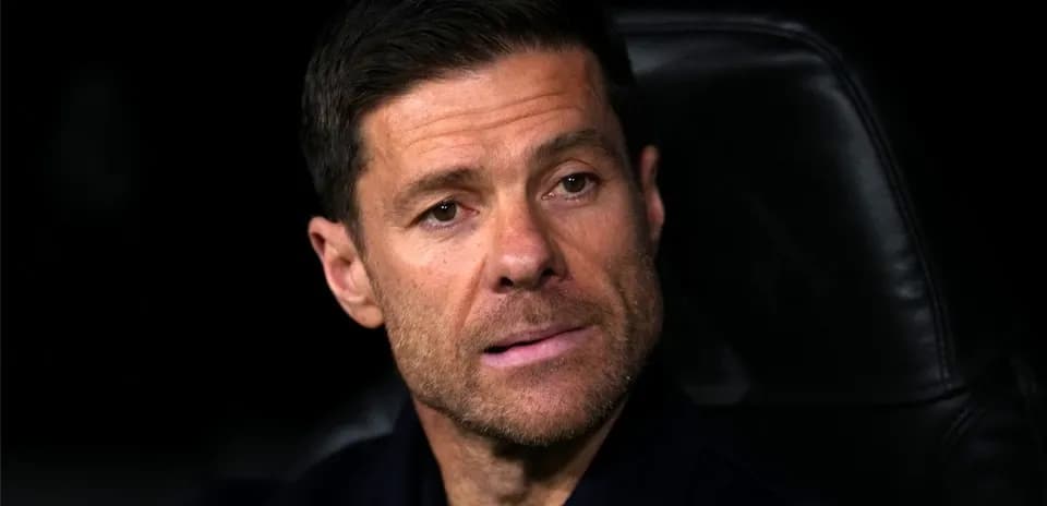 Coach seated on bench during match observation