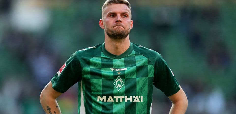 Player in green jersey during match at stadium