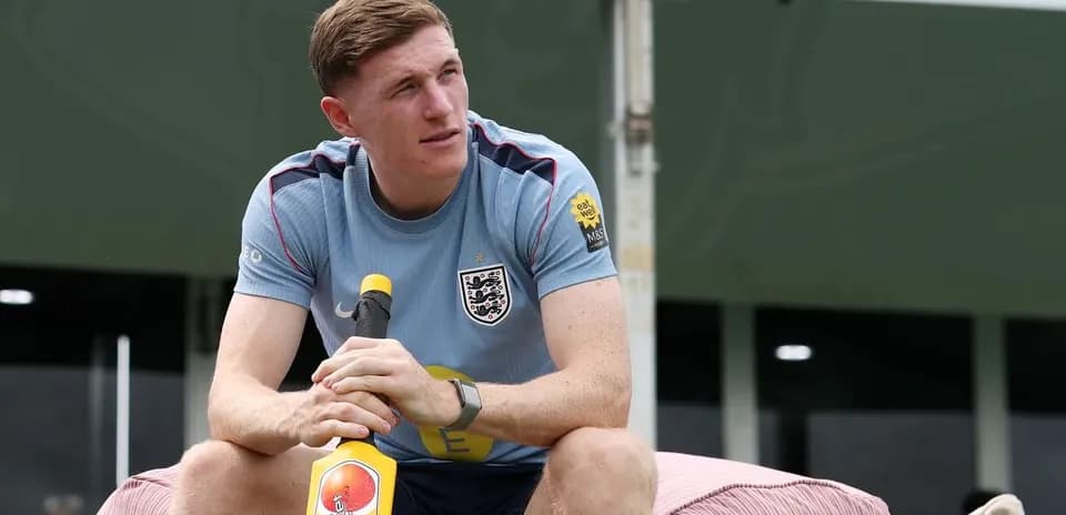 Player sitting with a cricket bat during training