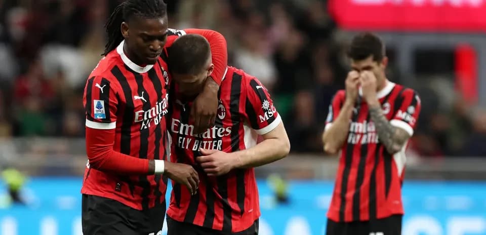 AC Milan players comforting each other after match
