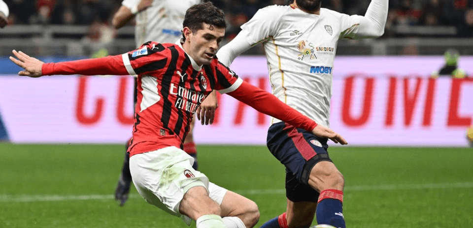AC Milan player tackling Cagliari opponent