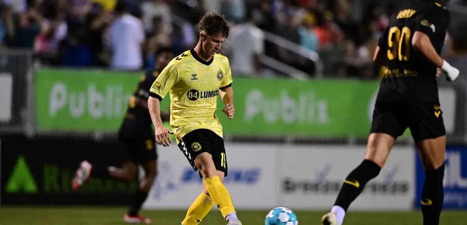 Player kicking ball during Charleston Battery match