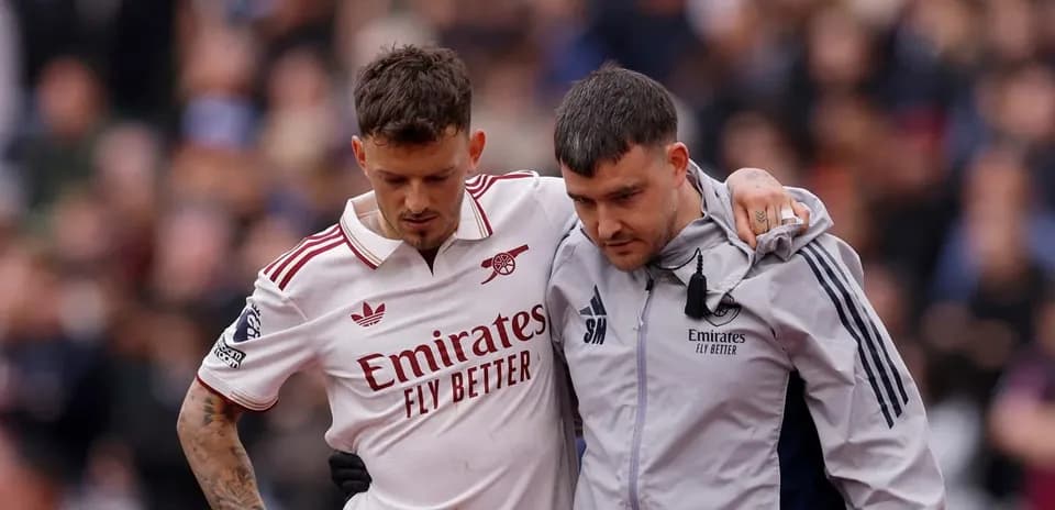 Player receiving assistance off the pitch after injury