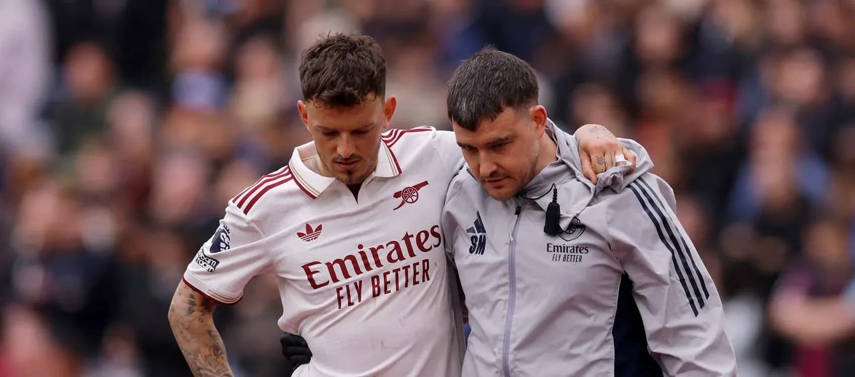 Player receiving assistance off the pitch after injury