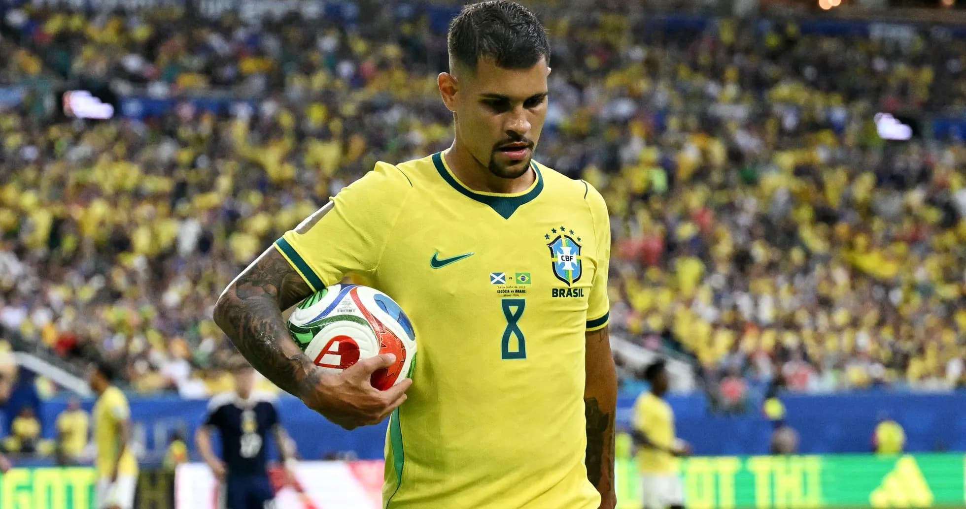 Brazilian player holding a soccer ball on field