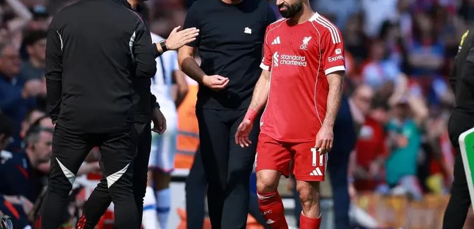 Mohamed Salah walking off with coaching staff