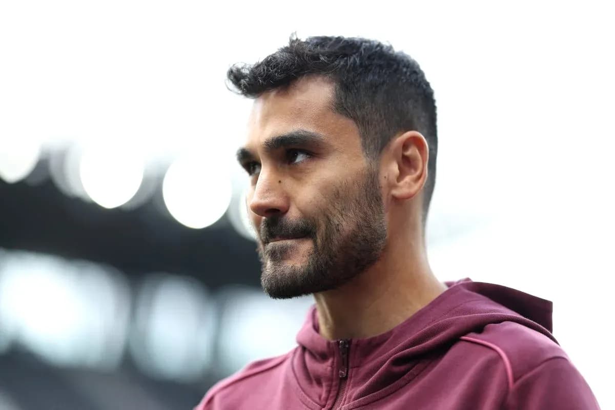 Football player in maroon jacket during training session