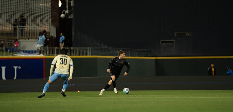 Player dribbling the ball during USL match