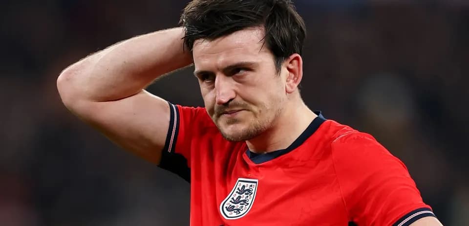 Player in red jersey with England crest looking concerned