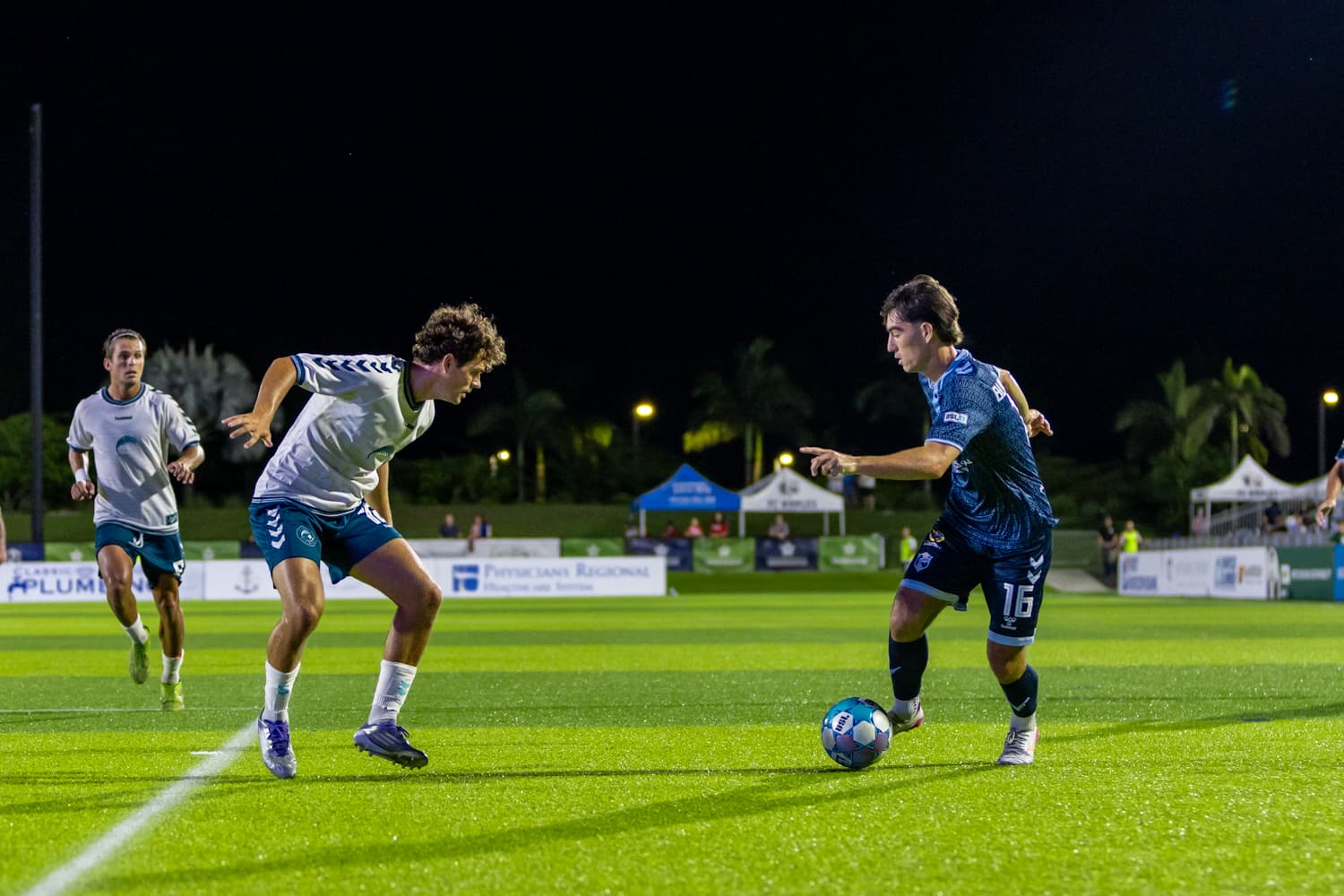 Players competing for the ball in USL match