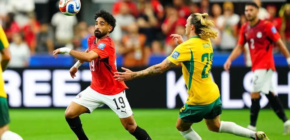 Egyptian player attempting to control ball against Australia