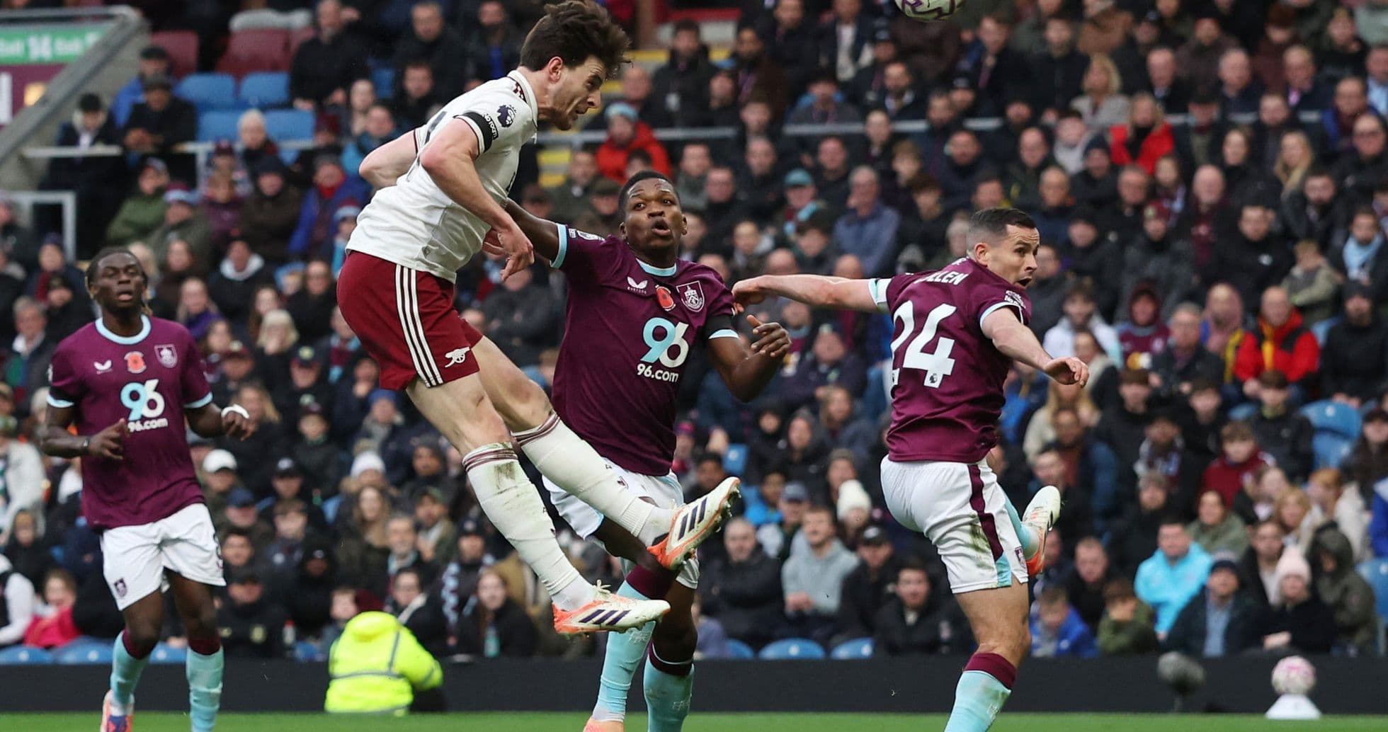 Arsenal player jumping to head the ball