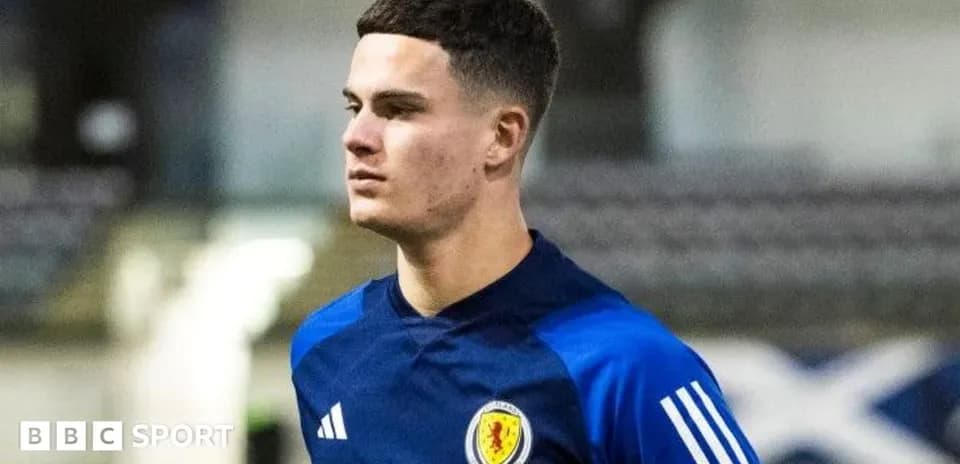 Player in Scotland training kit on pitch