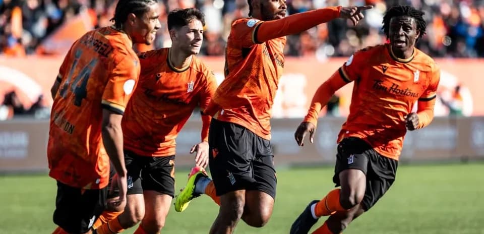 Players celebrating a goal during Forge match