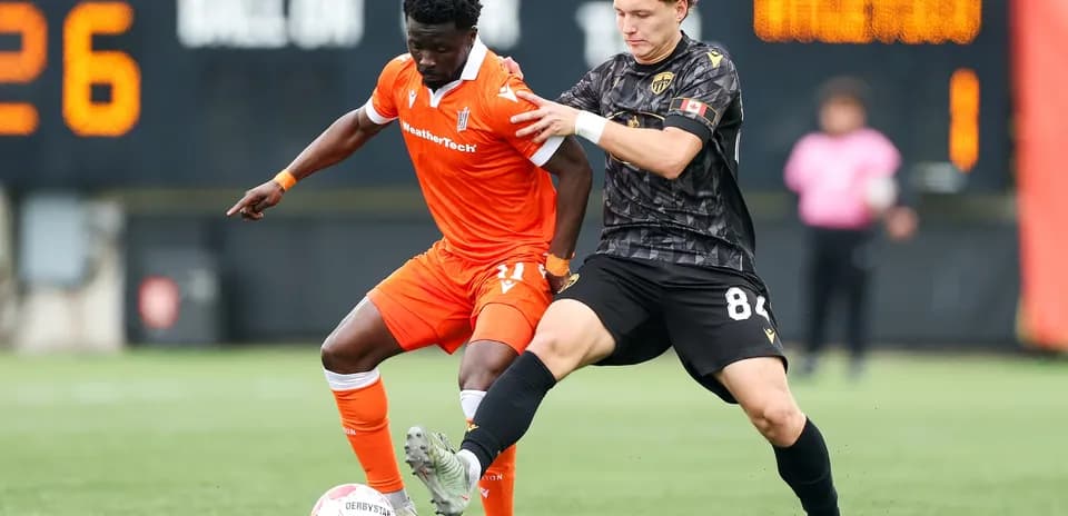 Two players competing for the ball in match