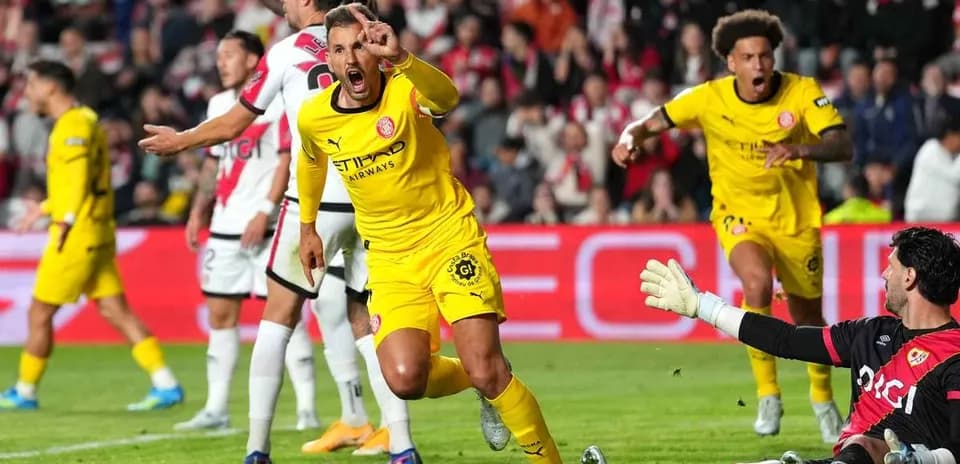 Players celebrating after scoring a goal during match